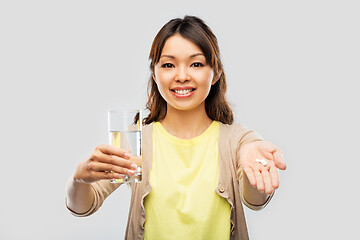 Image showing happy asian woman over grey background