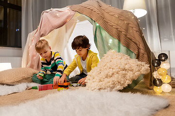 Image showing boys playing toy blocks in kids tent at home