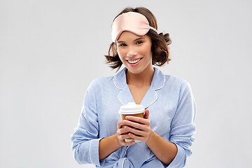 Image showing woman in pajama and sleeping mask with coffee cup