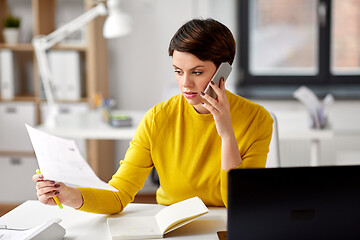 Image showing businesswoman calling on smartphone at office