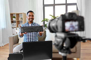 Image showing male blogger with keyboard videoblogging at home