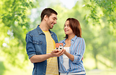 Image showing smiling couple holding house model