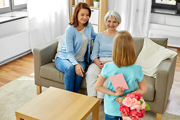 Image showing grandmother, mother and daughter with flowers