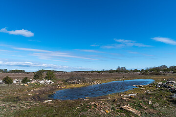 Image showing Water hole in a great barren landscape