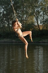 Image showing Rope swing river jump