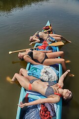 Image showing Canoeing on a river, girls in the boat