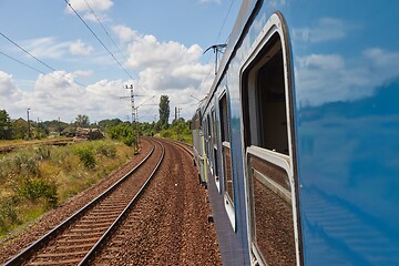 Image showing Railroad travel leaning out the window