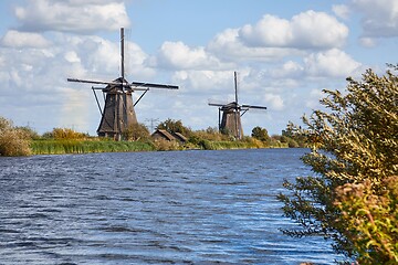 Image showing Windmill beside a canal