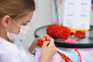 Image showing Sick girl crochets a lying in bed