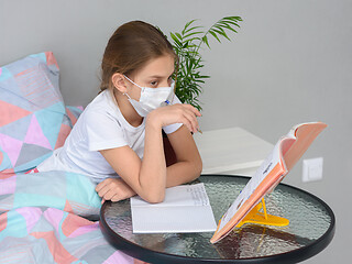 Image showing A girl in quarantine performs school homework