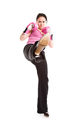 Image showing Kicking businesswoman with boxing gloves