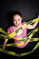 Image showing Businesswoman trapped in caution tape