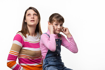 Image showing Mom wants to sneeze, daughter plugged her ears with fingers