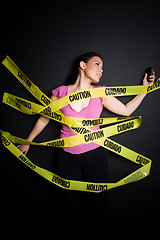 Image showing Businesswoman trapped in caution tape