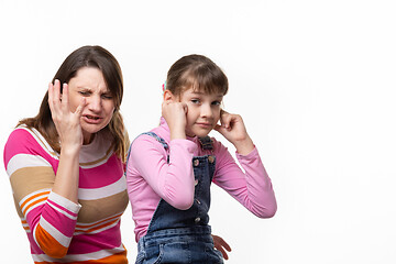 Image showing Girl sneezes, child plugged ears, isolated on white background