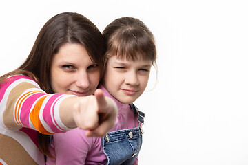 Image showing Mom squints her finger at the frame, her daughter also squinted at the frame