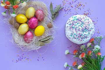 Image showing pattern of Easter eggs in the nest and Easter cake on a purple background