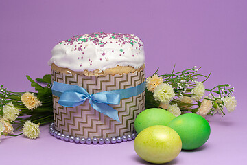 Image showing beautifully decorated Easter cake with yellow-green eggs and flowers