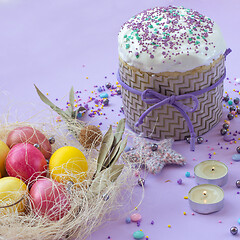 Image showing Easter cake and painted eggs beautifully decorated on a lilac background