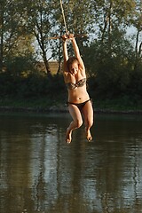 Image showing Rope swing river jump