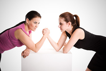 Image showing Two businesswomen arm wrestling