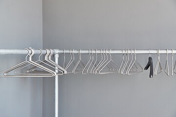 Image showing Empty cloakroom hangers at a canceled evend