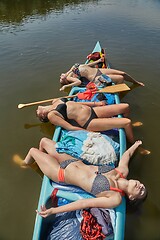 Image showing Canoeing on a river, girls in the boat