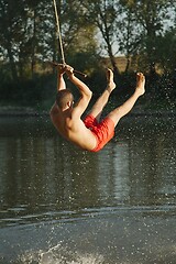 Image showing Rope swing river jump