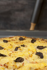 Image showing Baked quattro formaggi pizza in rectangular oven griddle.