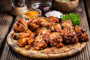 Image showing Hot chicken wings with different spices and dips