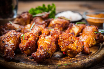 Image showing Hot chicken wings with different spices and dips