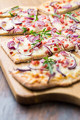 Image showing Flammkuchen - Traditional French dish tarte flambee cream cheese, bacon and onions