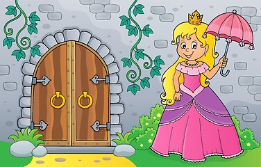 Image showing Princess with umbrella by old door