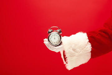 Image showing Santa holding an old alarm clock