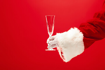 Image showing Santa Holding Champagne wineglass over red