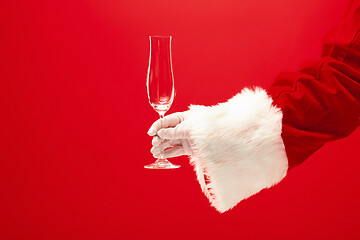 Image showing Santa Holding Champagne wineglass over red