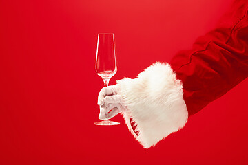 Image showing Santa Holding Champagne wineglass over red