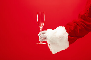 Image showing Santa Holding Champagne wineglass over red