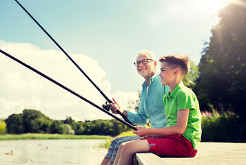 Image showing grandfather and grandson fishing on river berth