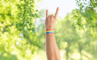 Image showing hand with gay pride rainbow wristband shows rock