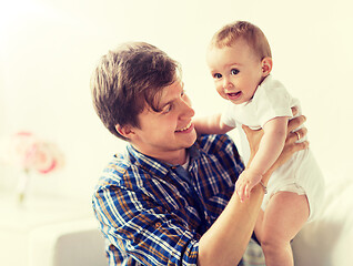 Image showing happy young father with little baby at home