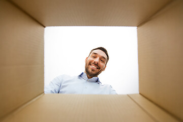 Image showing man looking into open parcel box
