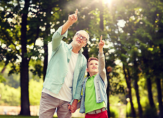 Image showing grandfather and boy pointing up at summer park