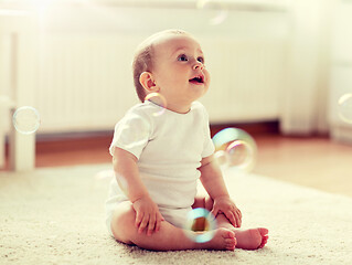 Image showing happy baby with soap bubbles at home