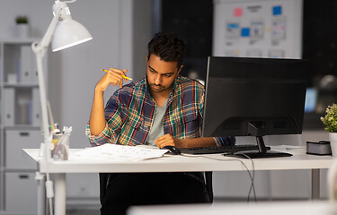 Image showing creative man with papers working at night office