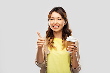 Image showing asian woman drinking coffee and showing thumbs up