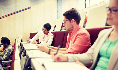 Image showing group of students with notebooks in lecture hall