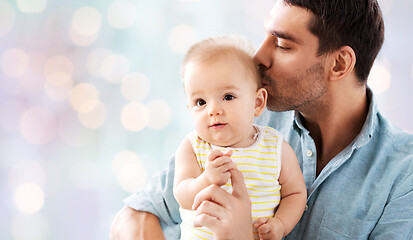 Image showing father kissing little baby daughter