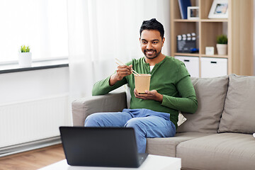 Image showing indian man with laptop eating takeout food at home