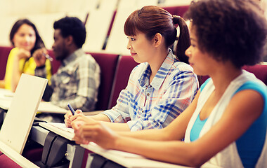 Image showing group of students talking in lecture hall